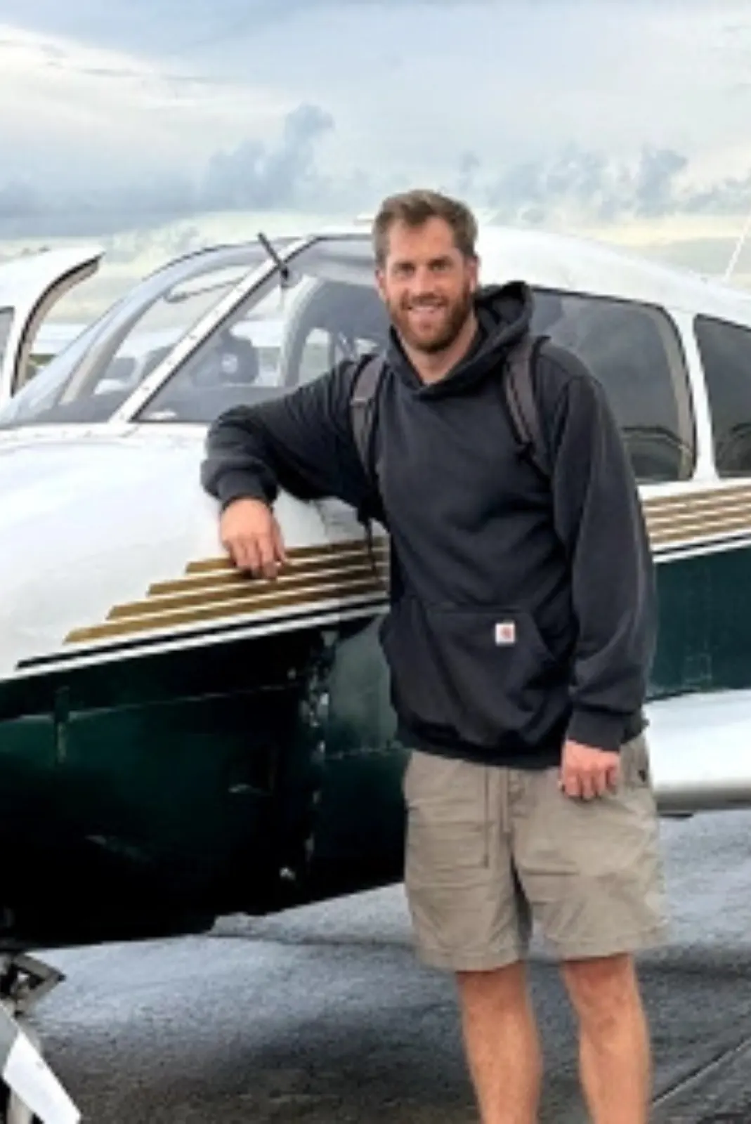 Airline Pilot Program student beside a training aircraft